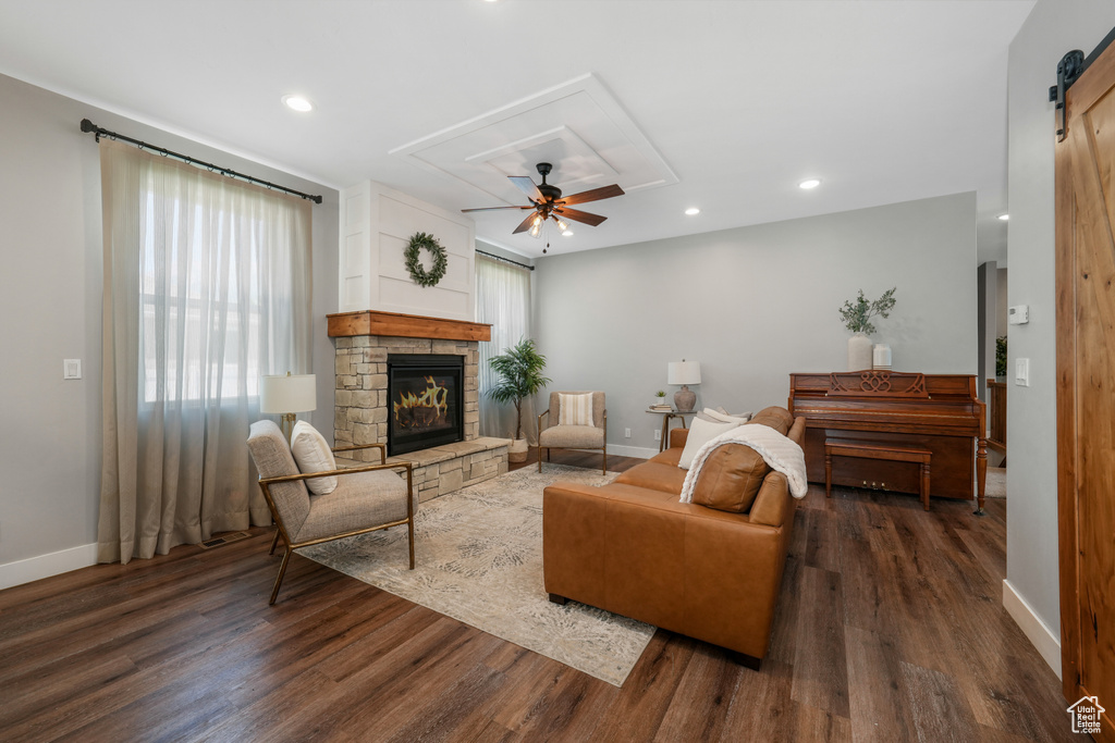 Living room with attic access, dark wood-style flooring, a fireplace, recessed lighting, and a ceiling fan
