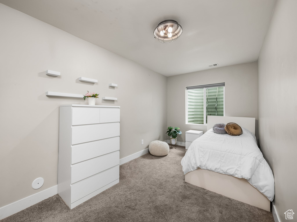 Carpeted bedroom with baseboards