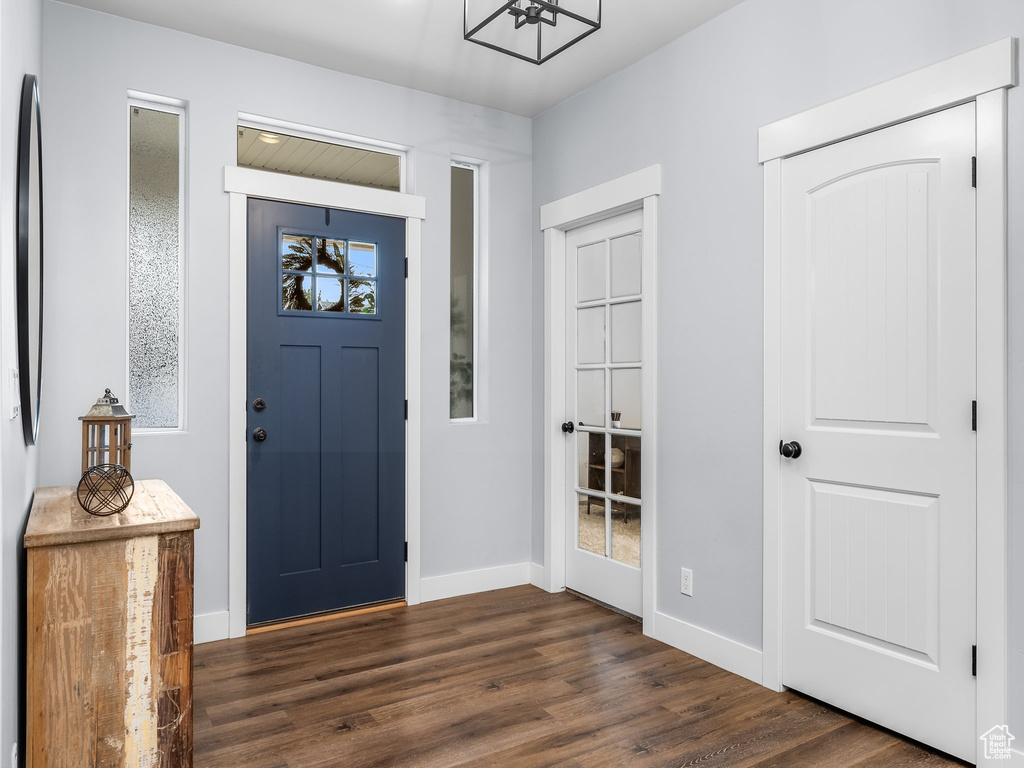 Entryway with dark wood-style flooring and baseboards