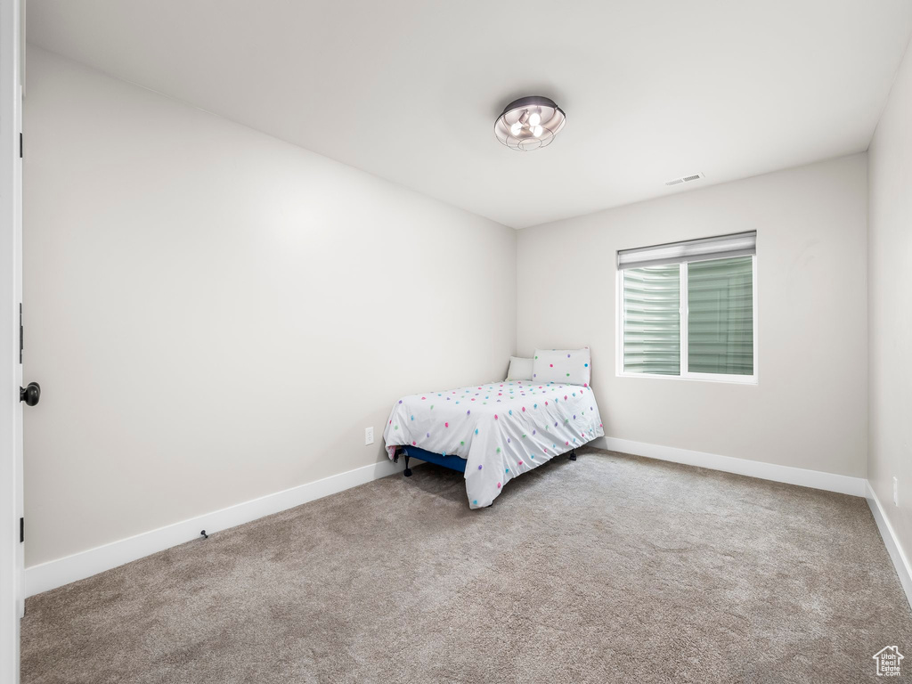 Carpeted bedroom featuring baseboards