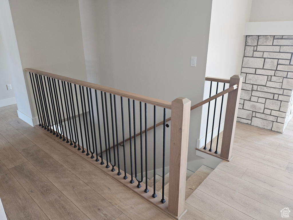 Stairs featuring wood finished floors