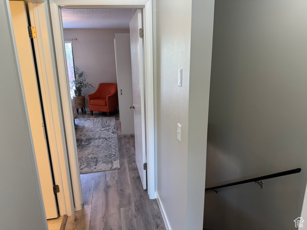 Corridor with wood finished floors and baseboards