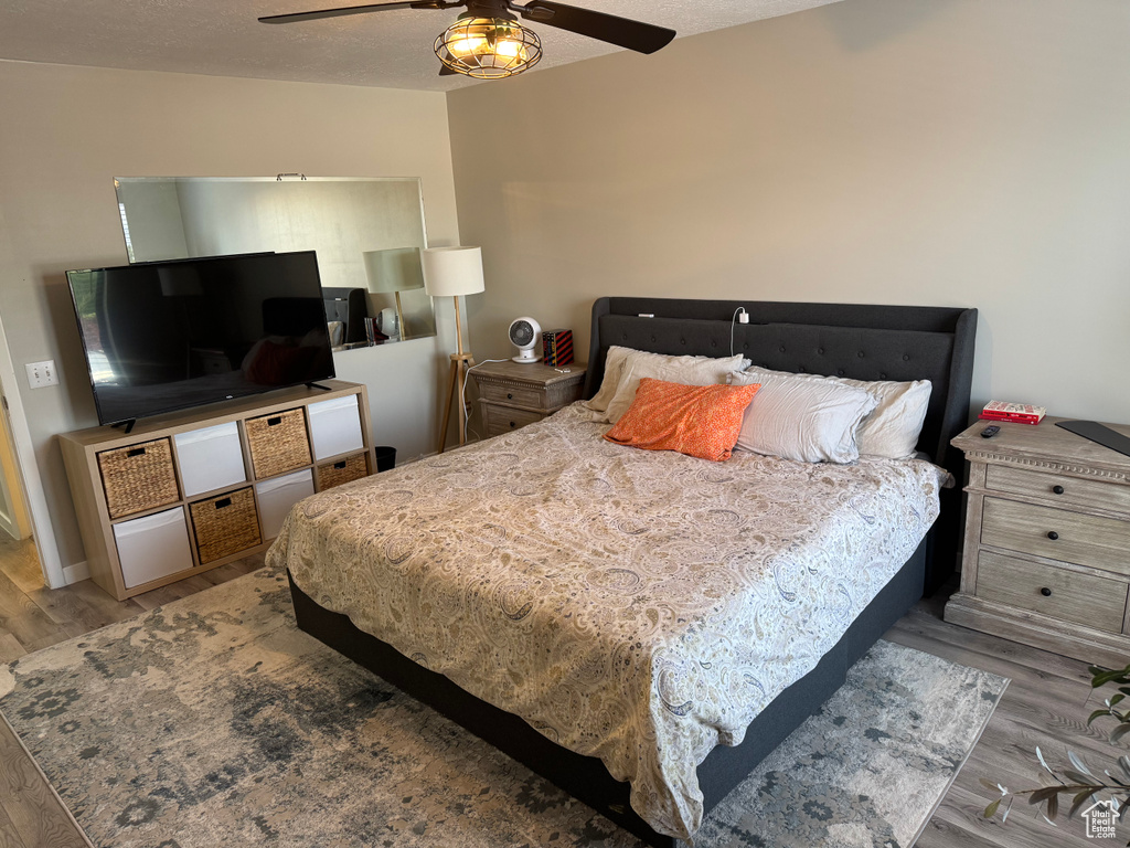 Bedroom with wood finished floors and ceiling fan