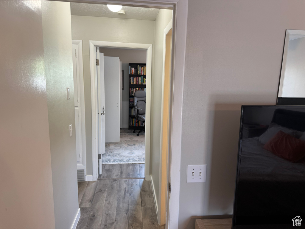 Hall featuring wood finished floors