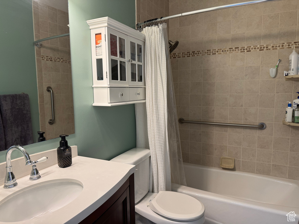 Full bath featuring vanity and shower / bath combination with curtain