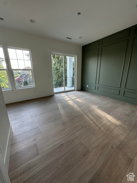 Spare room with wood finished floors and recessed lighting