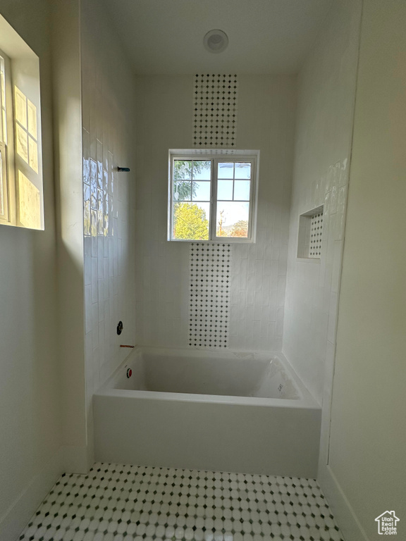 Full bath featuring tile patterned floors and shower / washtub combination
