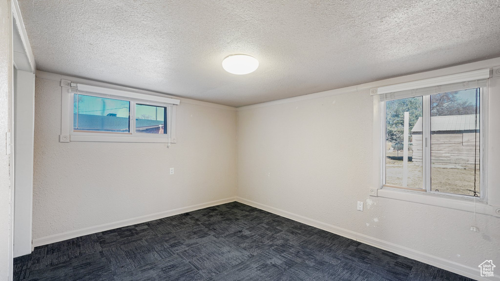 Unfurnished room with a textured ceiling