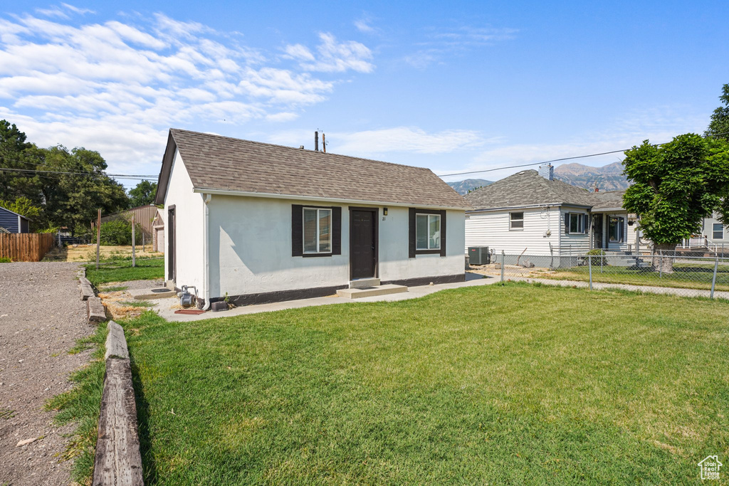 View of front facade featuring stucco siding and roof with shingles