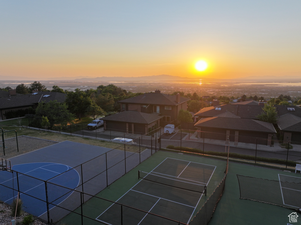 View of tennis court featuring a residential view