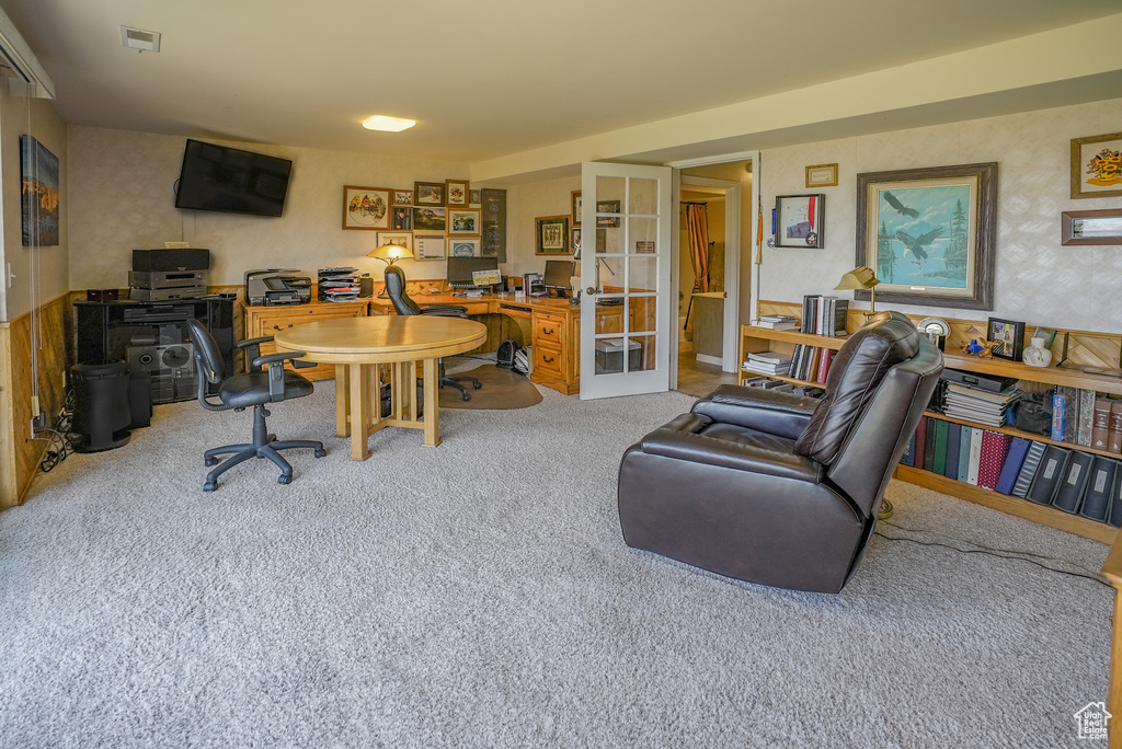 Office space with french doors and carpet flooring