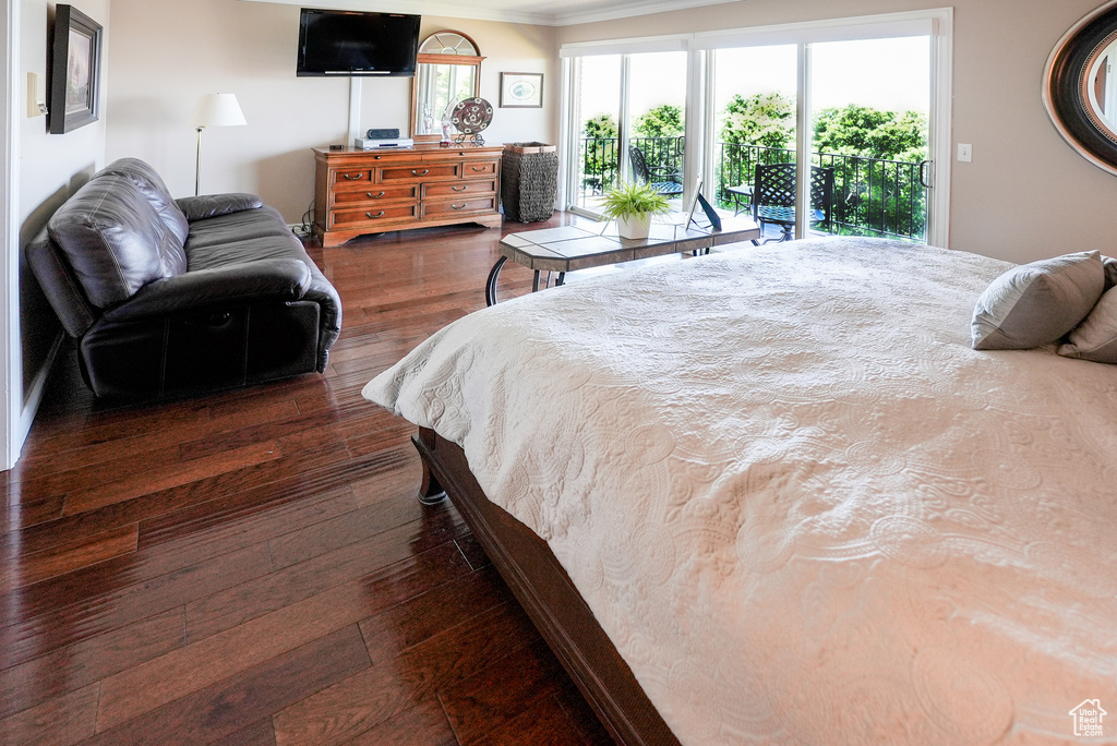 Bedroom featuring crown molding, access to exterior, and dark wood-type flooring