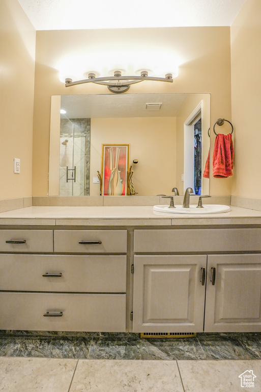Full bathroom featuring vanity and a stall shower