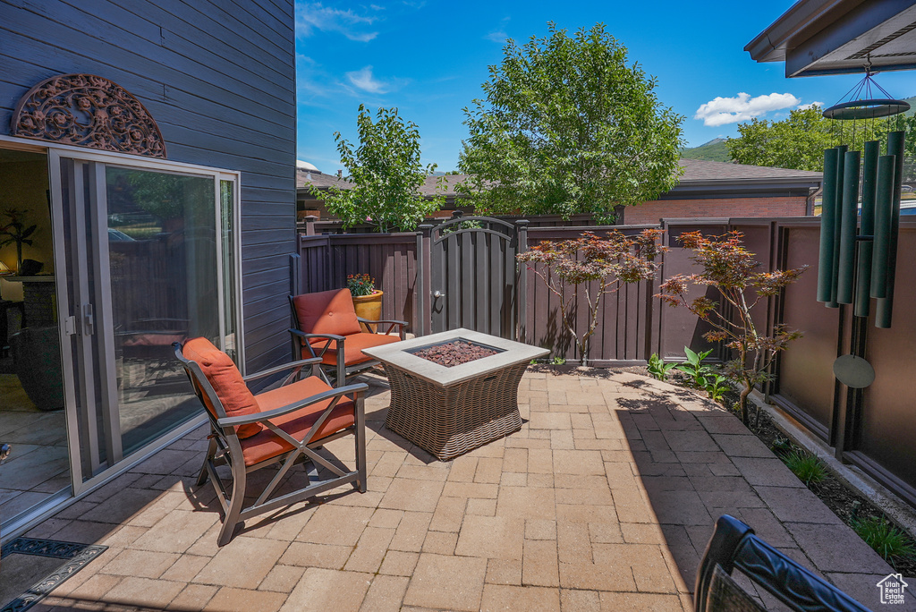 View of patio / terrace featuring a gate and a fire pit
