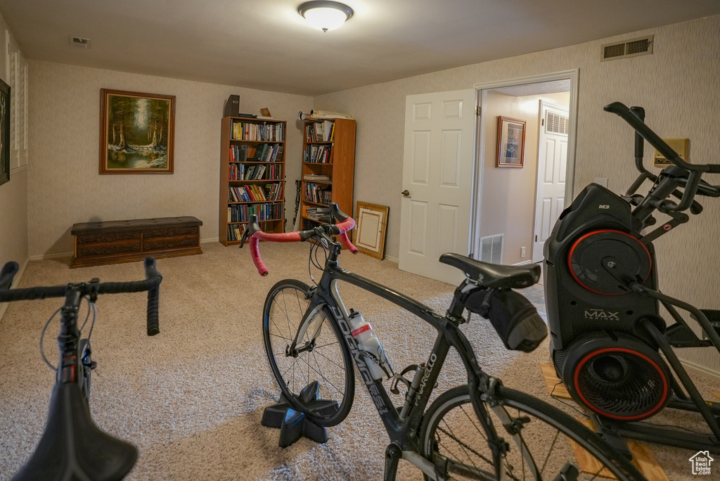 Exercise area featuring wallpapered walls and carpet flooring