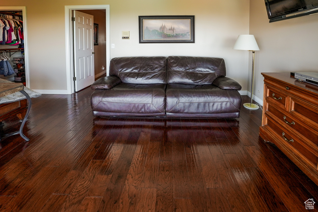 Living room featuring baseboards and hardwood / wood-style flooring