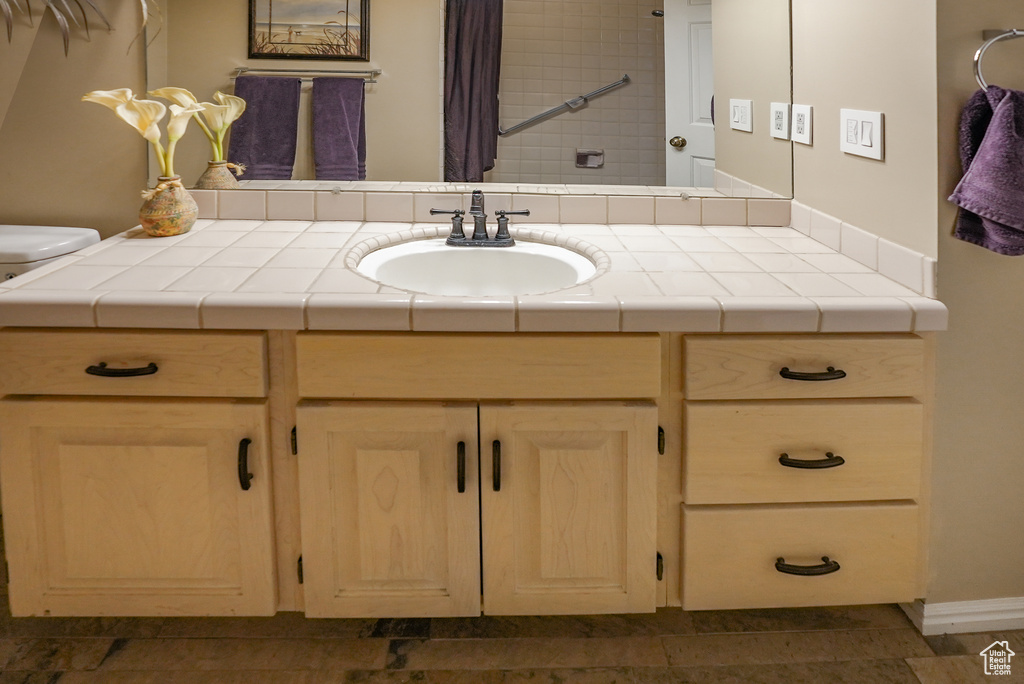 Full bath with vanity and curtained shower