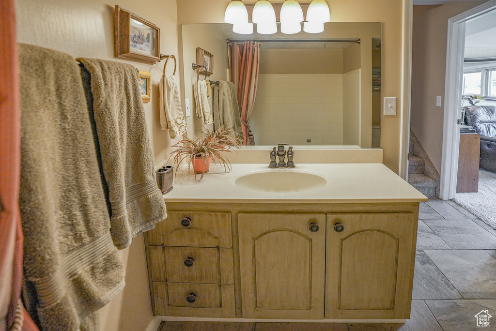 Bathroom with vanity and stone finish flooring