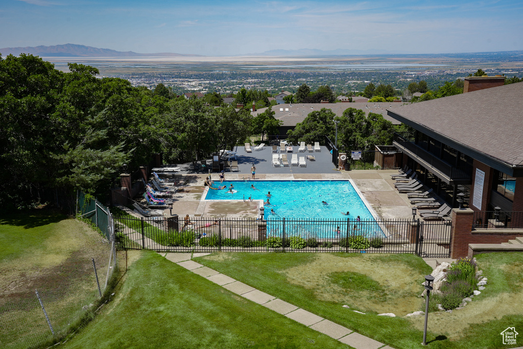 Community pool with a patio area and a mountain view