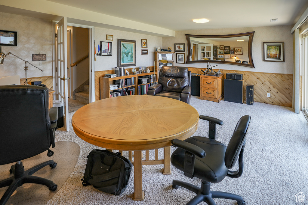 Carpeted home office featuring a wainscoted wall and wood walls