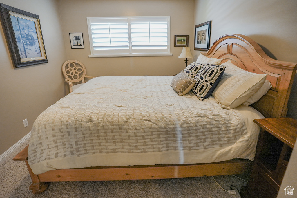 Bedroom featuring baseboards and carpet floors
