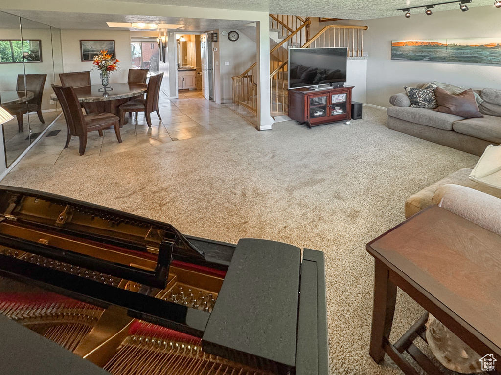 Living area with stairway and baseboards