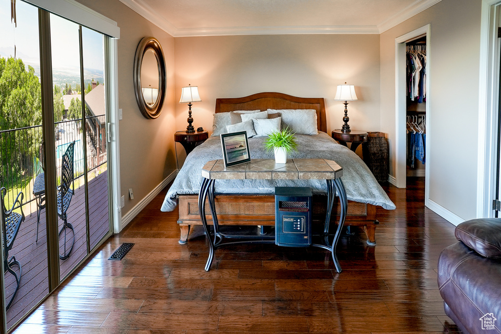 Bedroom featuring crown molding, hardwood / wood-style flooring, and access to outside