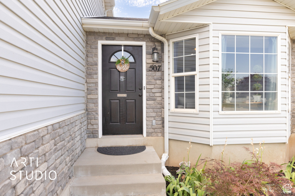 Entrance to property with stone siding