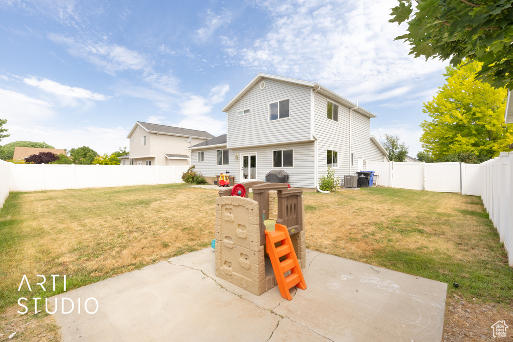 Back of house with a patio area and a fenced backyard