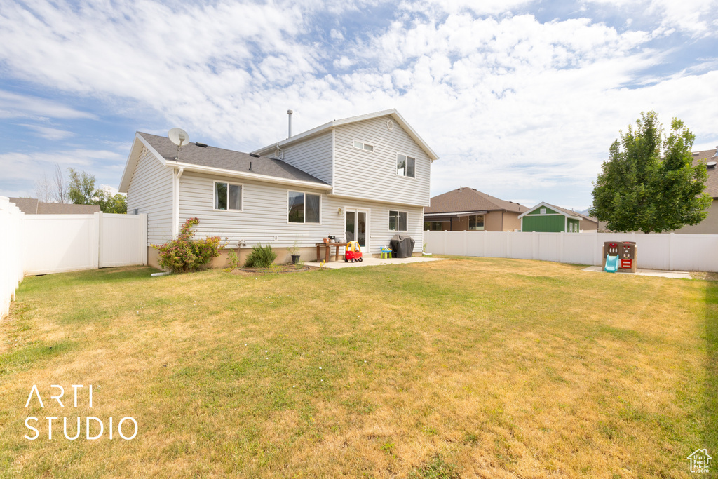 Back of property with a fenced backyard and a patio area