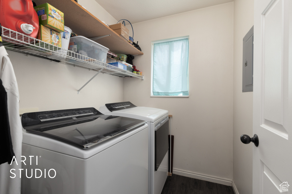 Laundry room with independent washer and dryer, dark wood-style floors, and electric panel
