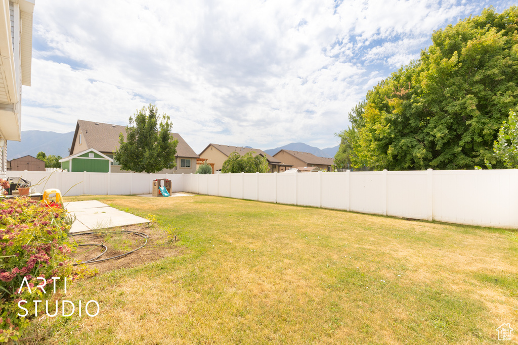 Fenced backyard with a mountain view