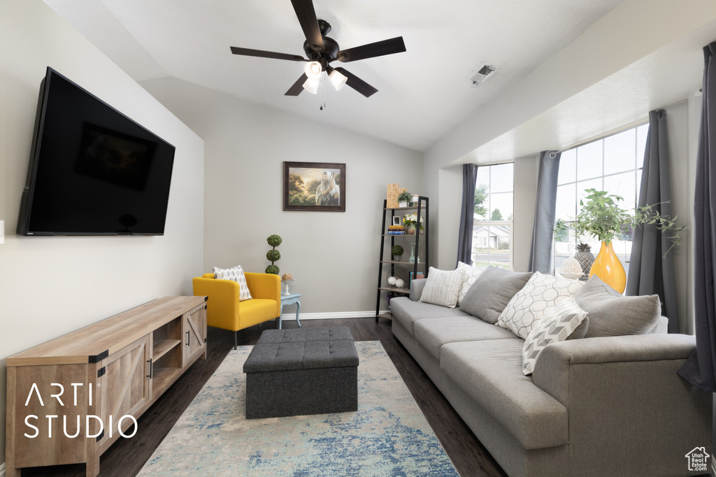 Living area featuring lofted ceiling, ceiling fan, and dark wood-style floors