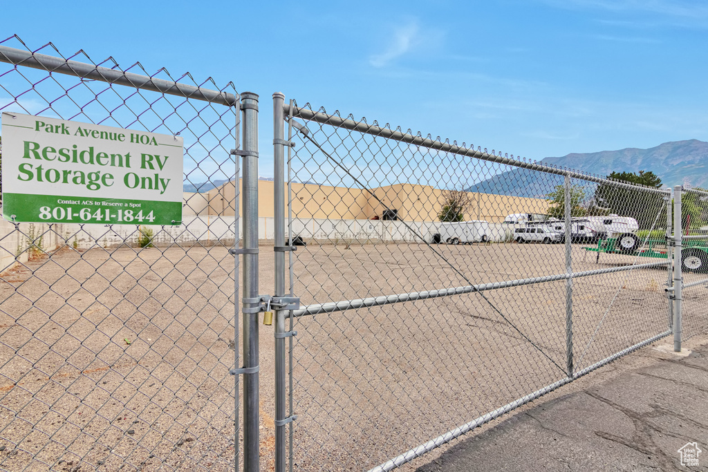 View of tennis court featuring a gate and a mountain view