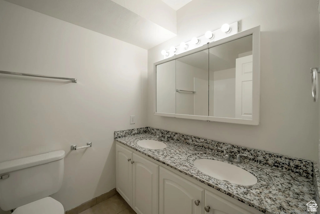 Bathroom featuring double vanity and tile patterned floors