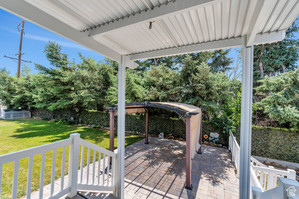 Wooden deck featuring a yard and a patio area