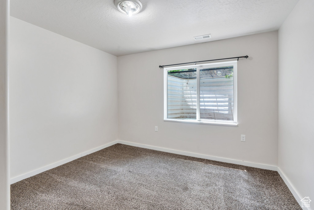 Empty room featuring carpet floors