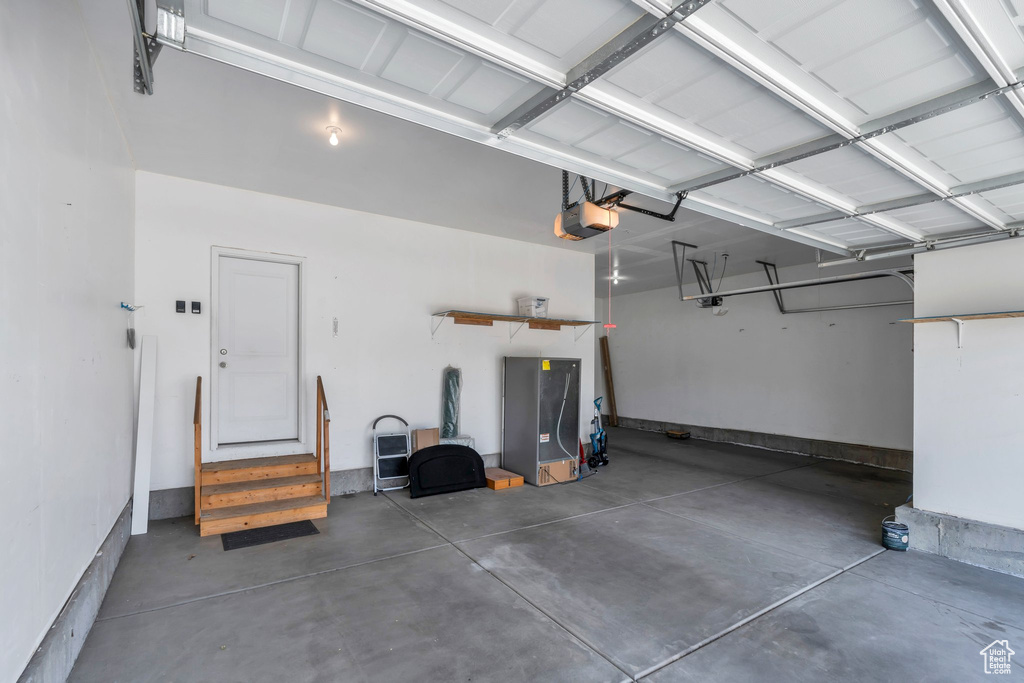 Garage featuring a garage door opener