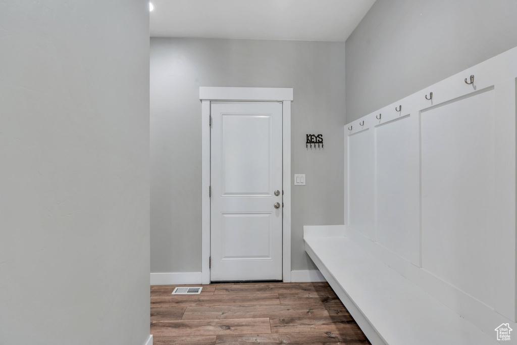 Mudroom featuring wood finished floors and baseboards