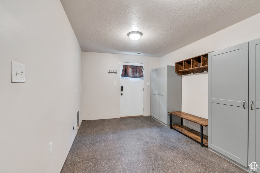 Mudroom with a textured ceiling
