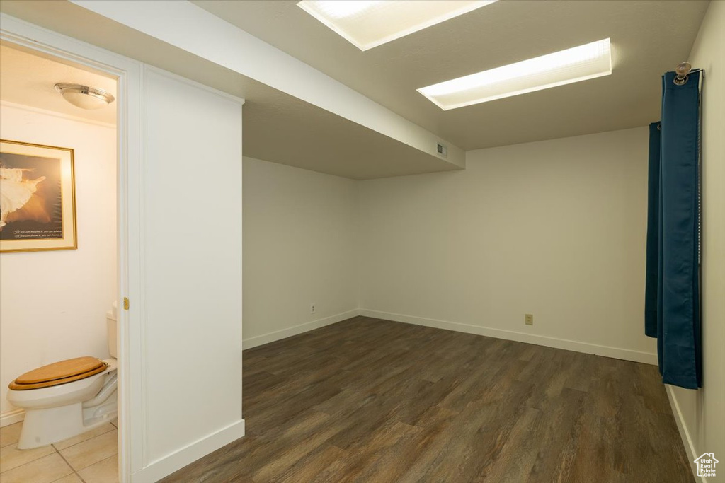 Finished basement with wood finished floors and baseboards