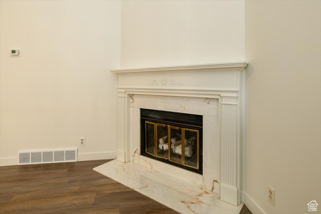 Detailed view of a premium fireplace and wood finished floors