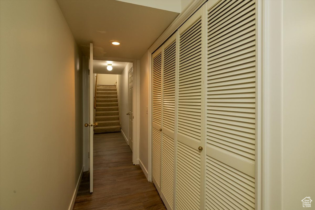 Hallway with recessed lighting and dark wood-style flooring