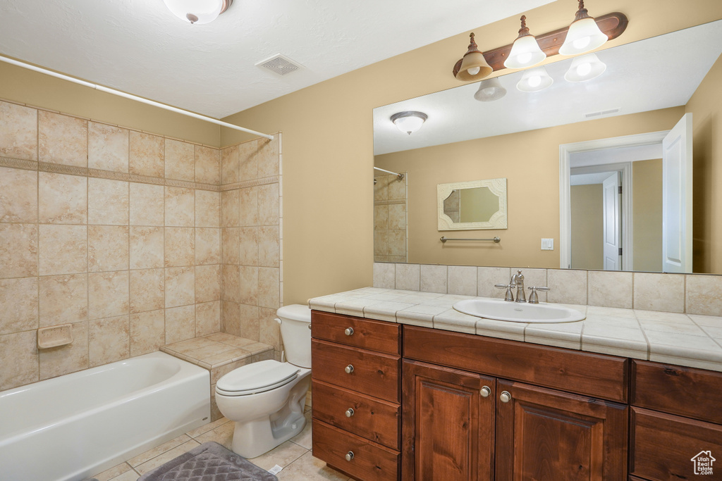 Full bathroom with vanity, tile patterned flooring, and tub / shower combination