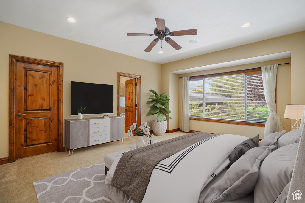 Bedroom with light colored carpet, recessed lighting, and a ceiling fan