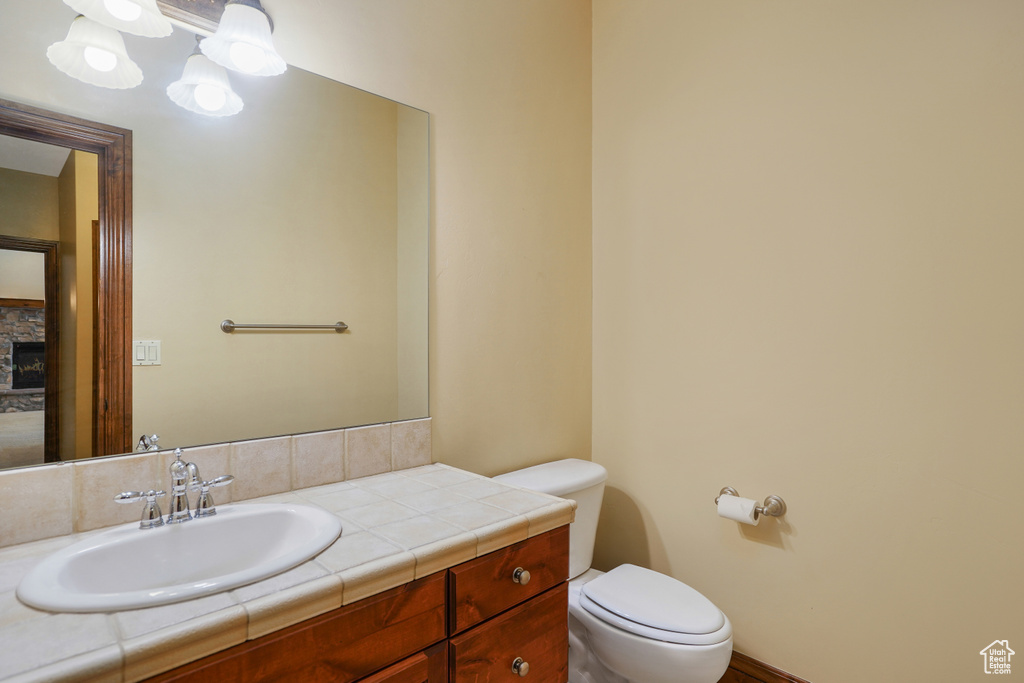 Half bath with vanity and a fireplace