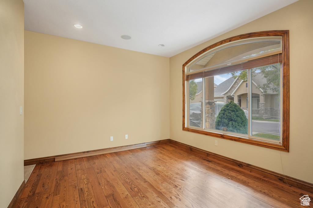 Spare room with wood finished floors and recessed lighting