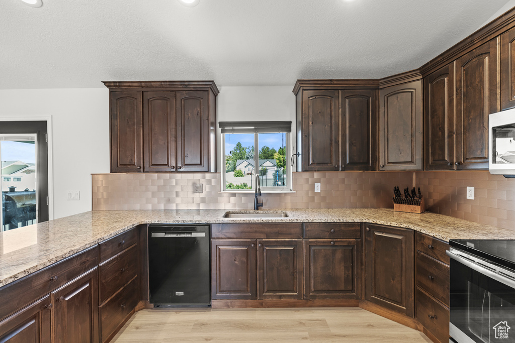Kitchen with dishwasher, stainless steel range with electric cooktop, light stone counters, tasteful backsplash, and dark brown cabinetry