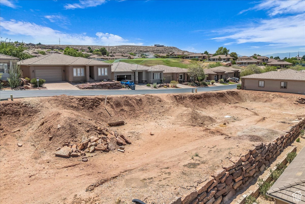 View of front of house with a residential view and a garage