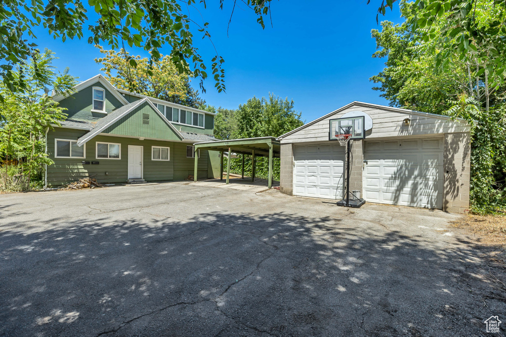View of front of home featuring an outbuilding and a garage